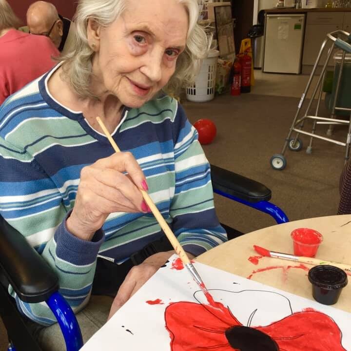 Resident taking part in art therapy - drawing a splendid poppy